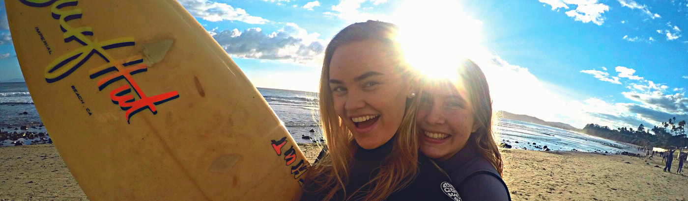 Happy surfing girl in California