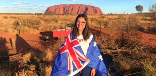 Student at Uluru with Australian flag